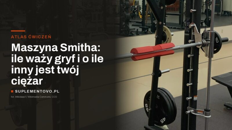 Gryf suwnicy Smitha na pionowych prowadnicach, po bokach trzpienie na talerze