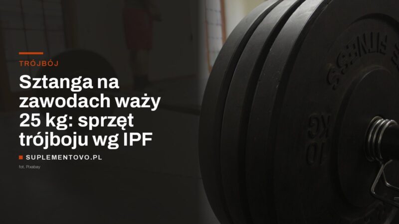 Sztanga z nałożonymi talerzami i zaciskiem sprężynowym na siłowni